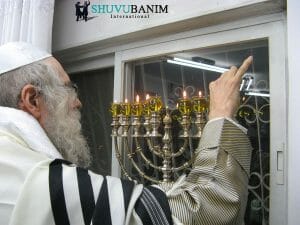 Rav Berland light Chanukah Menorah in his home in Jerusalem