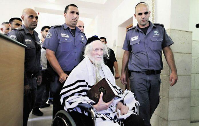 rav-berland-in-court-surrounded-by-police-in-wheel-chair