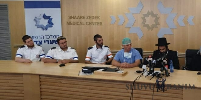 Medical personnel sitting with Gavriel Lavie at the press conference at Shaarei Tzedek hospital