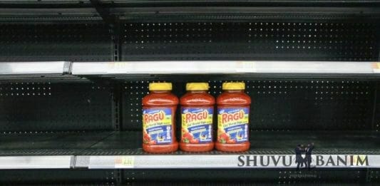 Empty shelves with 3 jars of sauce