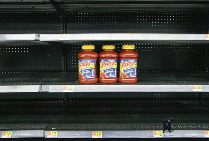 Empty shelves with 3 jars of sauce